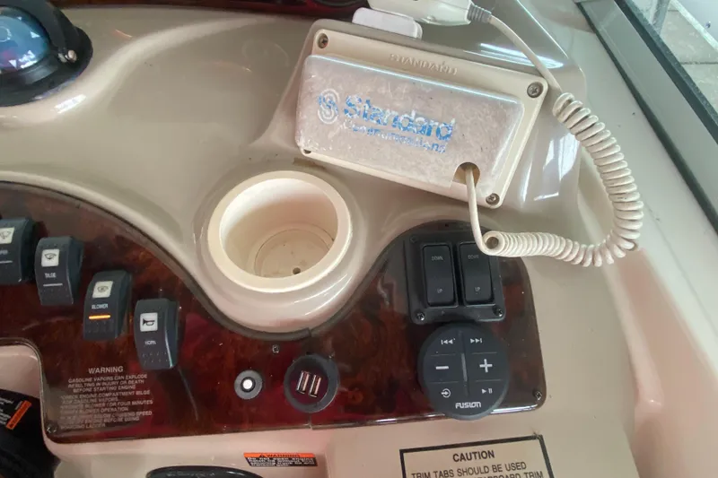 Slide: The Image of Control panel of a 2002 Rinker 342 Fiesta Vee boat with radio and switches. - 18