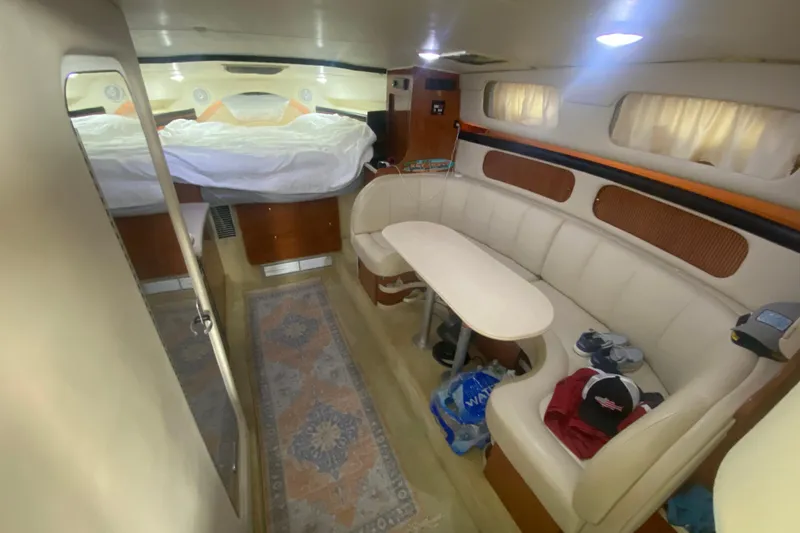 Slide: The Image of Interior of 2002 Rinker 342 Fiesta Vee boat with cozy seating and bed. - 23
