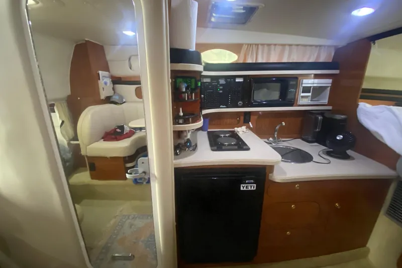 Slide: The Image of 2002 Rinker 342 Fiesta Vee interior with kitchenette and seating area. - 25