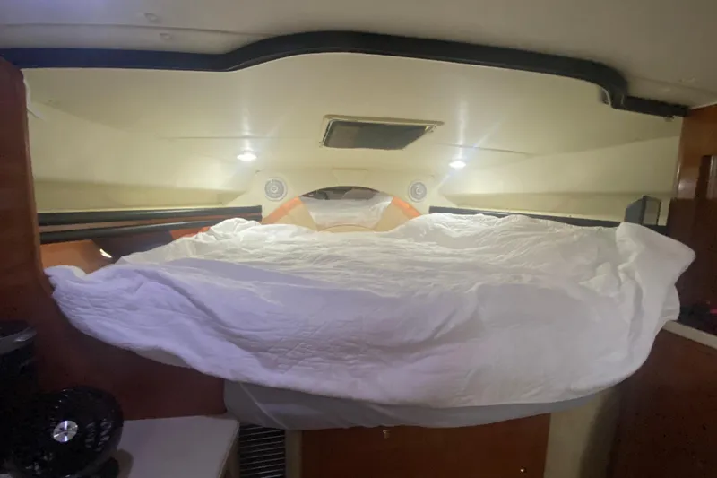Slide: The Image of Cozy cabin interior of 2002 Rinker 342 Fiesta Vee with bed and lighting. - 27