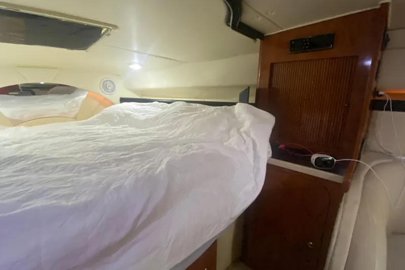 Slide: The Image of Interior cabin of 2002 Rinker 342 Fiesta Vee with bed and wooden cabinetry. - 28