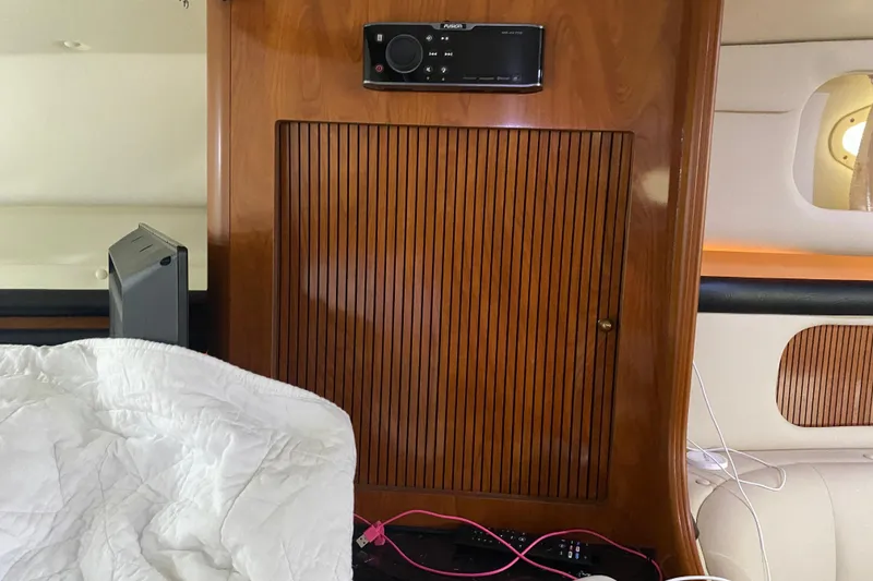 Slide: The Image of Interior of 2002 Rinker 342 Fiesta Vee boat with wood paneling and stereo system. - 29