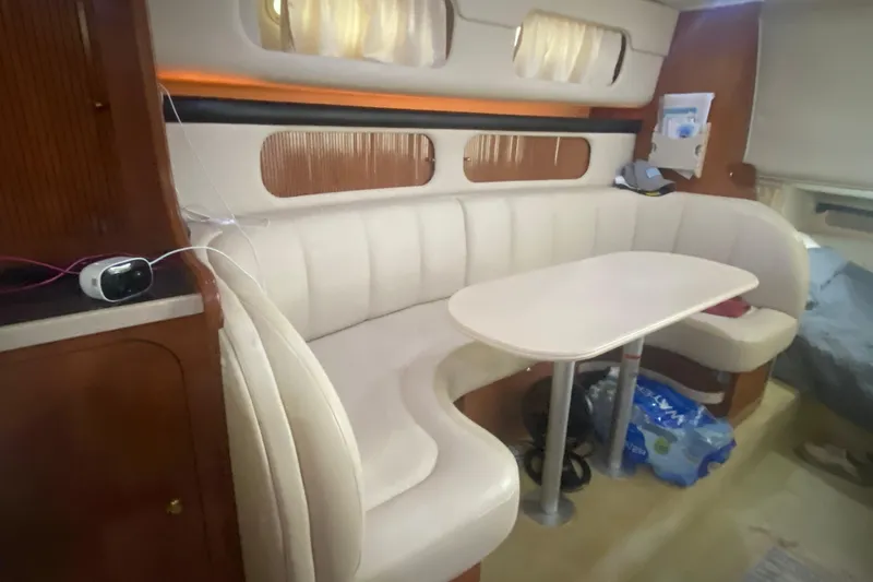 Slide: The Image of Interior of 2002 Rinker 342 Fiesta Vee with curved seating and table. - 30