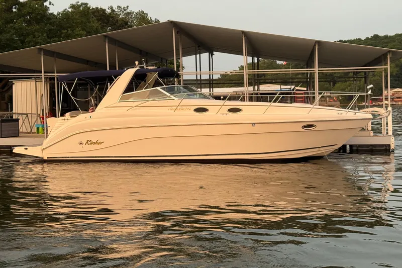 Slide: The Image of 2002 Rinker 342 Fiesta Vee boat docked at marina, calm water reflecting sunset. - 38