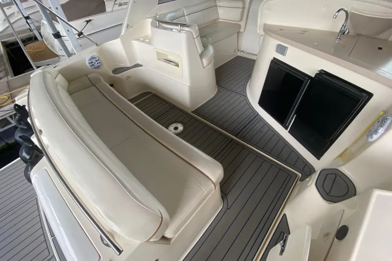 Slide: The Image of 2002 Rinker 342 Fiesta Vee boat interior with seating, kitchenette, and storage. - 4