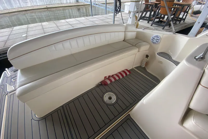Slide: The Image of 2002 Rinker 342 Fiesta Vee boat interior with white seating and striped cushion. - 5