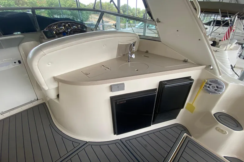 Slide: The Image of 2002 Rinker 342 Fiesta Vee boat interior with kitchenette and seating area. - 6