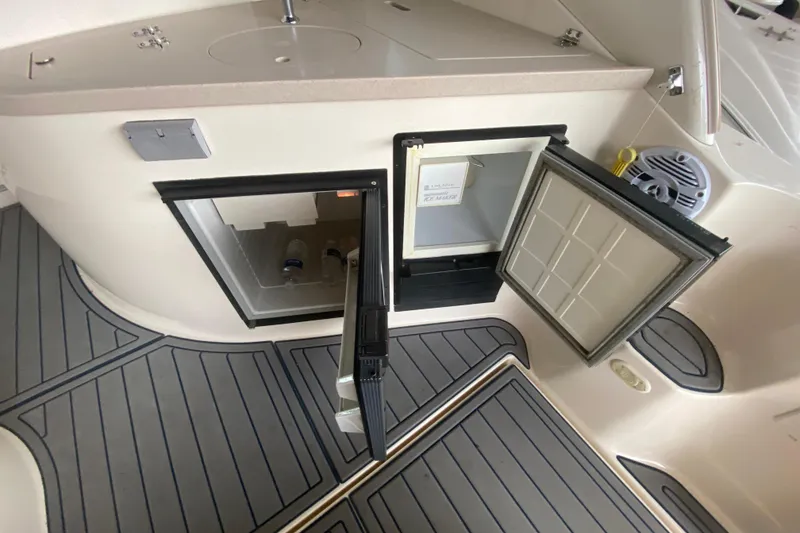 Slide: The Image of 2002 Rinker 342 Fiesta Vee boat interior with open mini fridge and sink. - 7