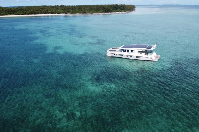 Slide: The Image of Luxurious Serenity 64 yacht cruising in clear turquoise waters, 2018 model. - 14