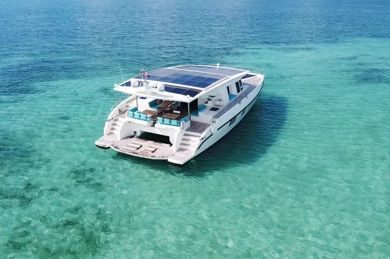 Slide: The Image of Luxurious 2018 Serenity 64 yacht with solar panels on turquoise water. - 2