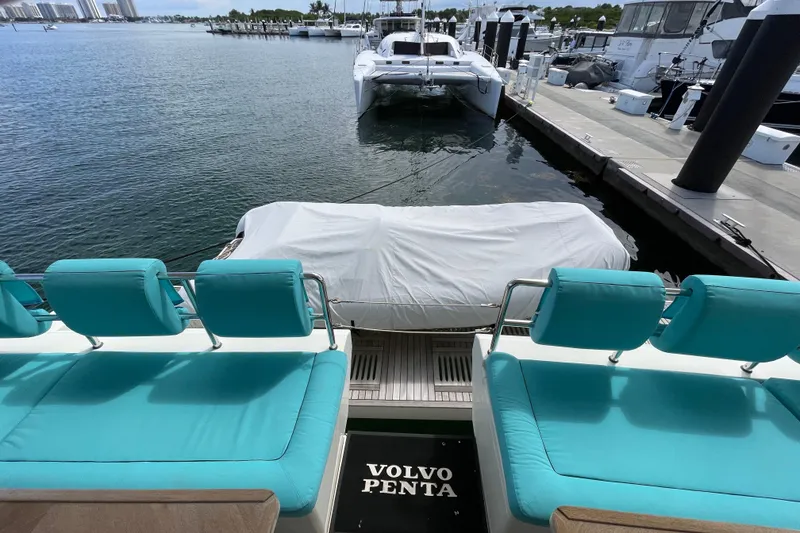 Slide: The Image of Luxurious Serenity 64 yacht with turquoise seating, docked at marina, 2018 model. - 21
