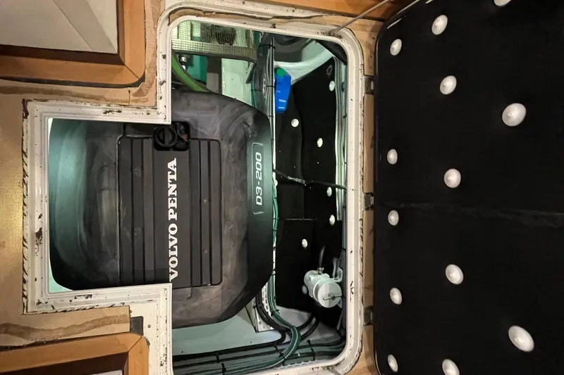 Slide: The Image of Engine compartment of a 2018 Serenity 64 yacht featuring a Volvo Penta D3-200 engine. - 34