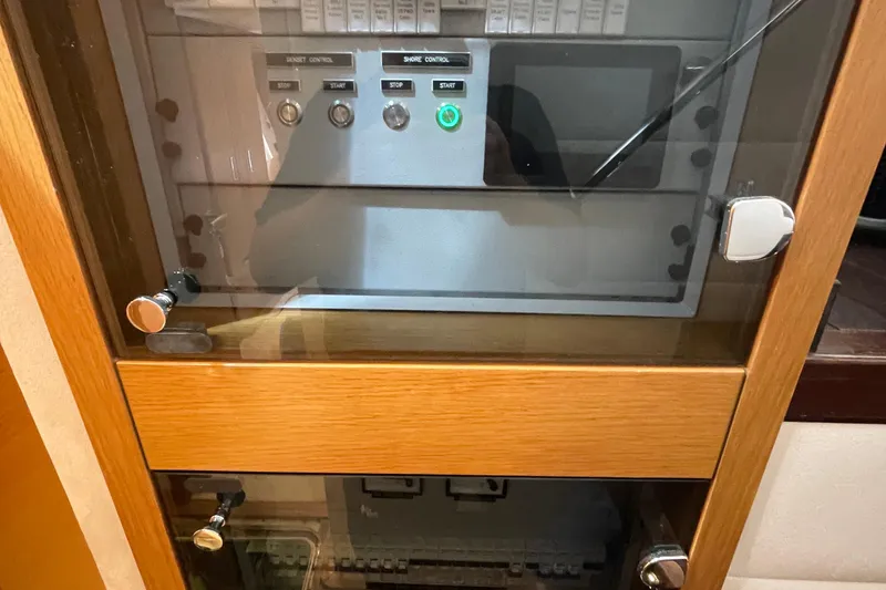 Slide: The Image of Control panel in a Serenity 64 yacht, 2018 model, with wooden cabinet and glass door. - 37