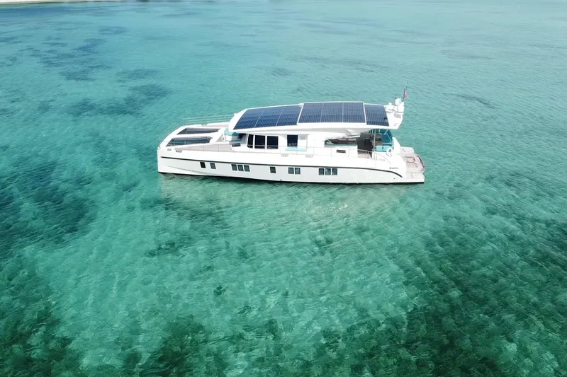 Slide: The Image of Aerial view of 2018 Serenity 64 yacht with solar panels on turquoise water. - 4