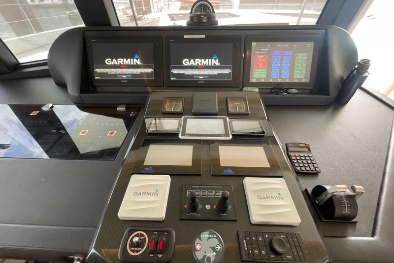 Slide: The Image of Control panel of a 2018 Serenity 64 yacht with Garmin navigation systems. - 40