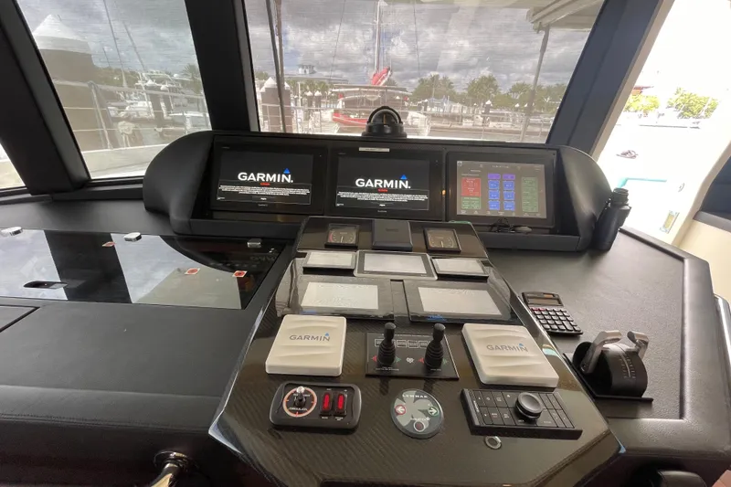 Slide: The Image of Control panel of a 2018 Serenity 64 yacht with Garmin navigation displays. - 42