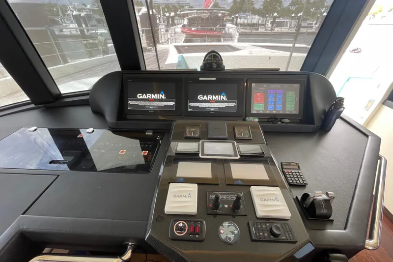 Slide: The Image of Cockpit of 2018 Serenity 64 yacht with Garmin navigation displays and control panels. - 43
