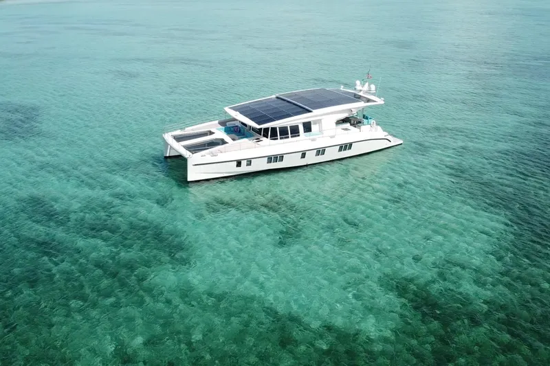 Slide: The Image of Solar-powered Serenity 64 yacht from 2018 on clear turquoise waters. - 5