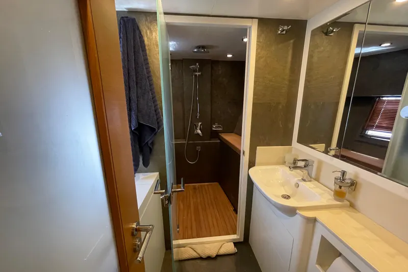 Slide: The Image of Luxurious yacht bathroom with modern shower, sink, and wooden accents, Serenity 64, 2018 model. - 57