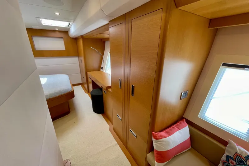 Slide: The Image of Luxurious 2018 Serenity 64 yacht cabin with modern wood interior and cozy seating. - 66