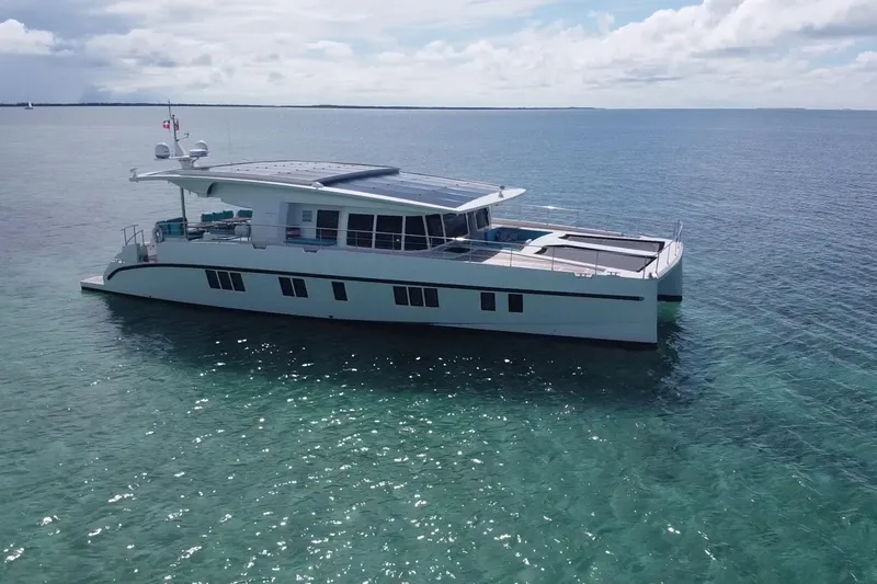 Slide: The Image of Luxurious 2018 Serenity 64 yacht cruising on clear blue ocean waters. - 9