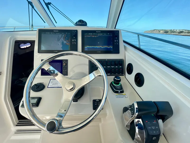 Slide: The Image of Helm of 2018 Boston Whaler 315 Conquest with navigation screens and controls. - 13