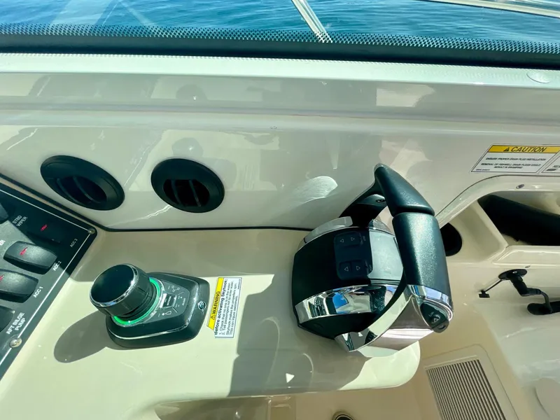 Slide: The Image of Control panel of a 2018 Boston Whaler 315 Conquest boat, featuring throttle and joystick. - 14