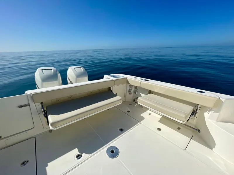 Slide: The Image of 2018 Boston Whaler 315 Conquest boat deck with ocean view and dual engines. - 25