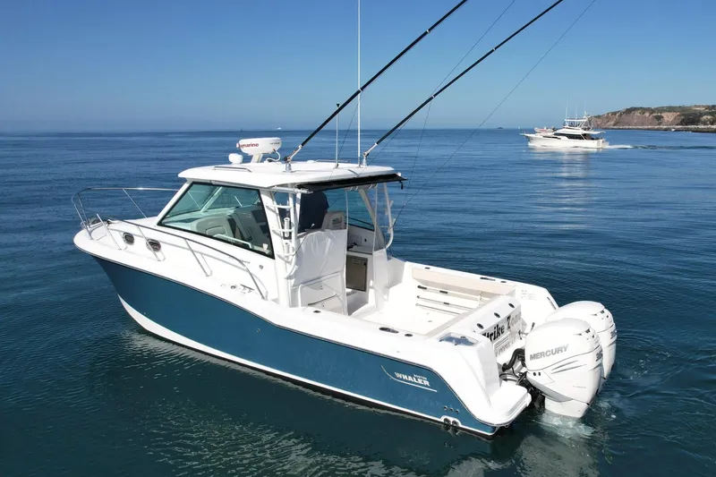 Slide: The Image of 2018 Boston Whaler 315 Conquest boat on calm ocean waters. - 7
