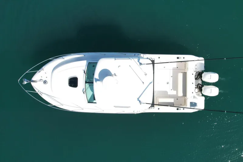 Slide: The Image of Overhead view of 2018 Boston Whaler 315 Conquest boat on clear water. - 9