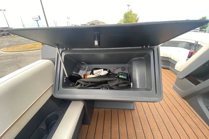 Slide: The Image of 2024 Manitou 22 MAX Explore Navigator Stealth storage compartment with various items inside. - 18