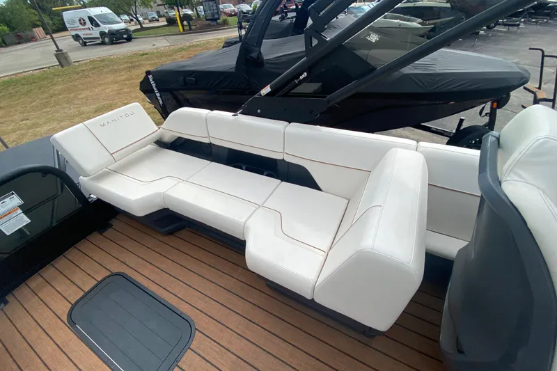 Slide: The Image of 2024 Manitou 22 MAX Explore Navigator Stealth boat with luxurious white seating. - 20