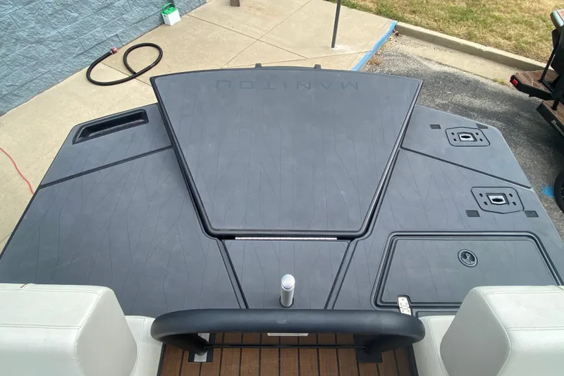 Slide: The Image of 2024 Manitou 22 MAX Explore Navigator Stealth boat deck, featuring sleek design and modern features. - 23