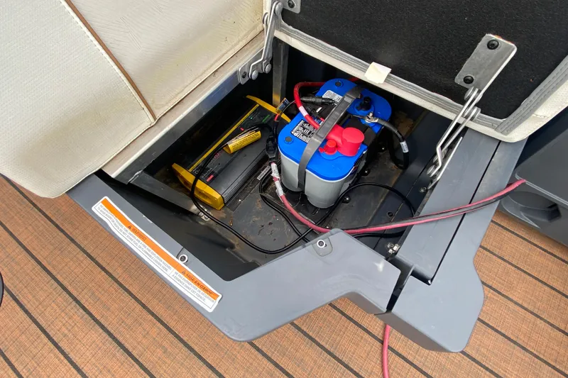 Slide: The Image of 2024 Manitou 22 MAX Explore Navigator Stealth battery compartment with wiring and components. - 27