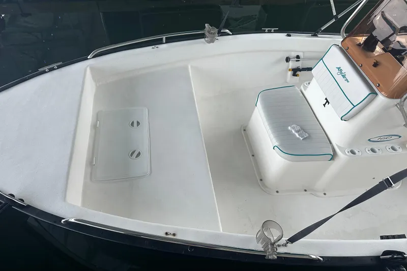 Slide: The Image of 2006 Key Largo 160 Center Console boat interior with seating and storage compartments. - 11
