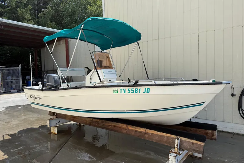 Slide: The Image of 2006 Key Largo 160 Center Console boat with teal canopy on display. - 3