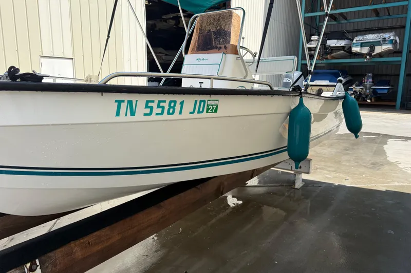 Slide: The Image of 2006 Key Largo 160 Center Console boat in storage with visible registration number. - 6