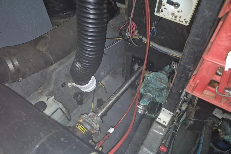 Slide: The Image of Engine room of a 1986 Sea Ray 410 Aft Cabin boat, showing mechanical components. - 12
