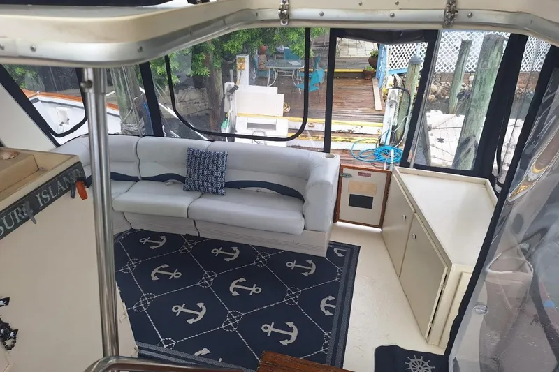 Slide: The Image of 1986 Sea Ray 410 Aft Cabin interior with nautical decor and comfortable seating. - 16
