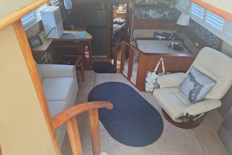 Slide: The Image of Interior of 1986 Sea Ray 410 Aft Cabin with cozy seating and nautical decor. - 22
