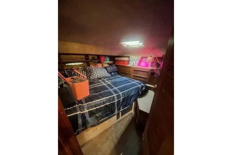 Slide: The Image of Cozy bedroom in 1986 Sea Ray 410 Aft Cabin with plaid bedding and decorative accents. - 25