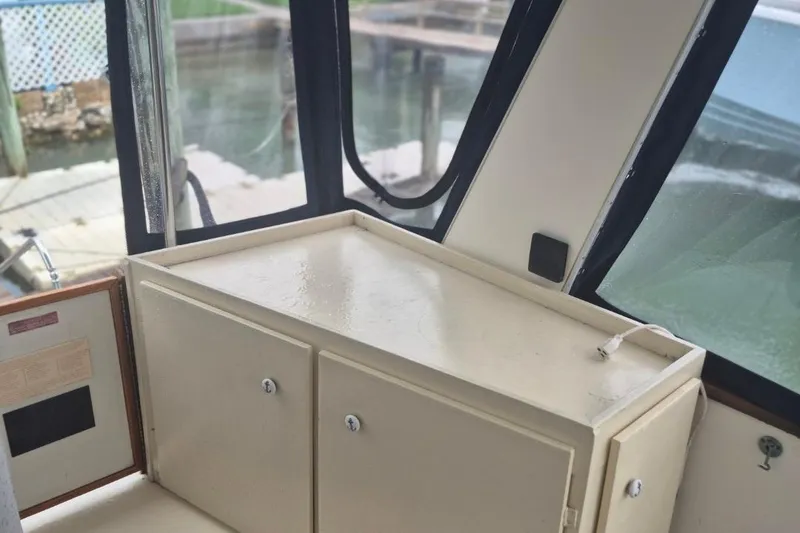 Slide: The Image of 1986 Sea Ray 410 Aft Cabin interior with storage cabinets and windows. - 3