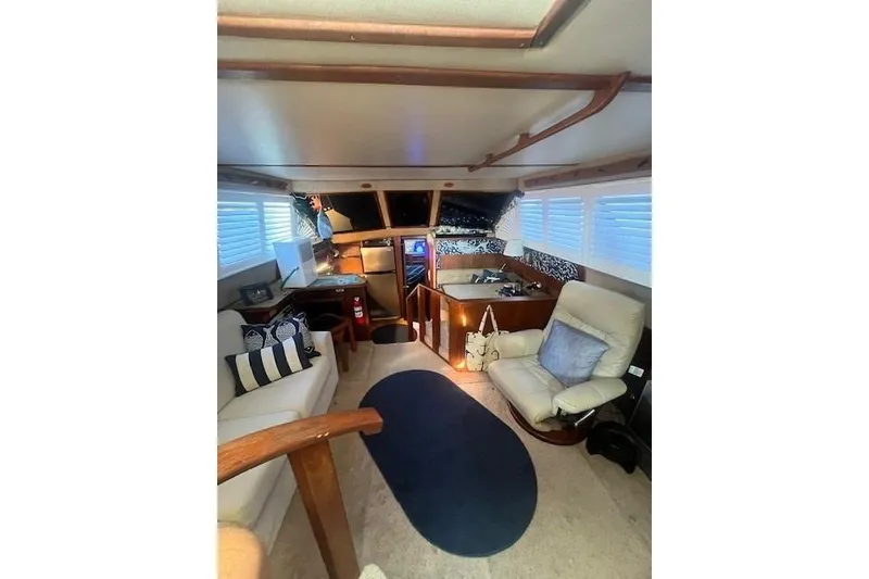 Slide: The Image of Interior of 1986 Sea Ray 410 Aft Cabin with cozy seating and nautical decor. - 30