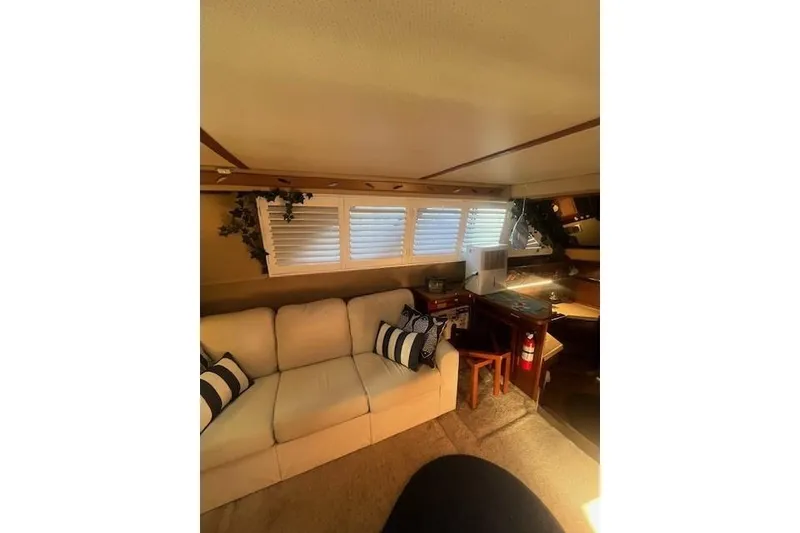 Slide: The Image of Interior of 1986 Sea Ray 410 Aft Cabin with cozy seating and nautical decor. - 31