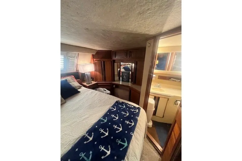 Slide: The Image of 1986 Sea Ray 410 Aft Cabin interior with cozy seating and entertainment area. - 34