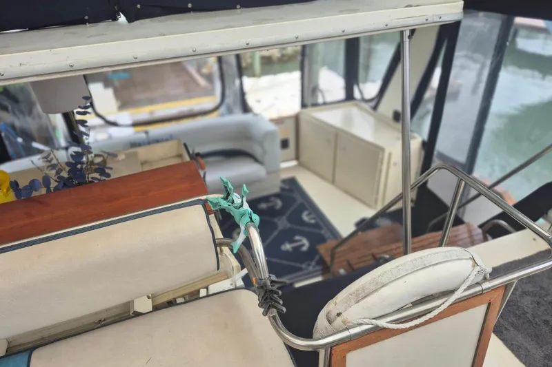 Slide: The Image of 1986 Sea Ray 410 Aft Cabin interior with nautical decor and seating area. - 8
