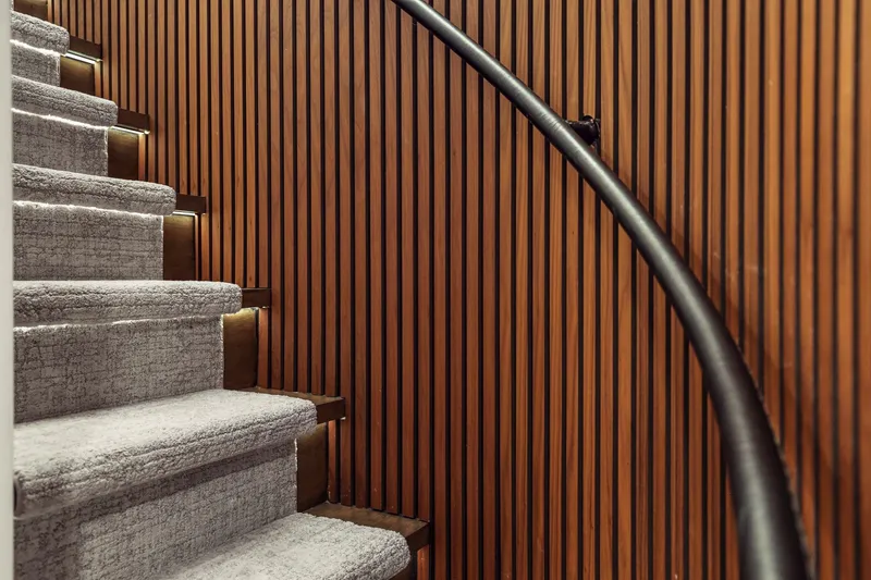 Slide: The Image of Carpeted stairs with wooden paneling and sleek black handrail on Mengi Yay 115 MY yacht. - 64