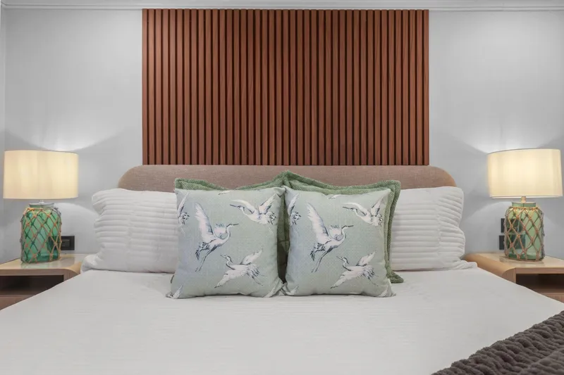 Slide: The Image of Luxurious bedroom on Mengi Yay 115 MY yacht, featuring elegant decor and bird-themed cushions. - 68