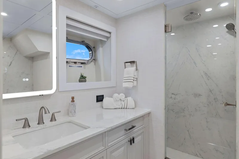 Slide: The Image of Luxurious yacht bathroom with marble shower, elegant fixtures, and porthole window on Mengi Yay 115 MY. - 72