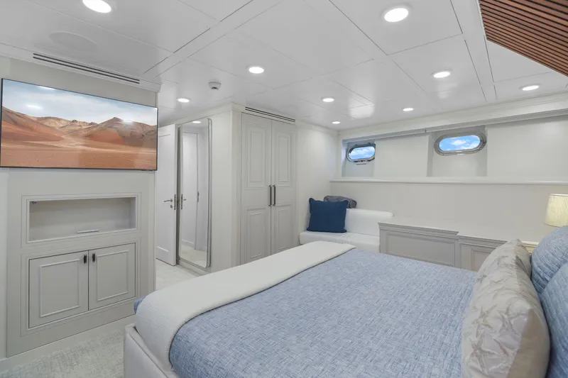 Slide: The Image of Luxurious bedroom interior on 2011 Mengi Yay 115 MY yacht with modern decor and porthole windows. - 74